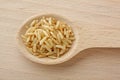 Wooden spoon filled with brown rice grains Royalty Free Stock Photo