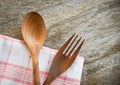 Wooden spoon and fork kitchenware set on napery on dining table Royalty Free Stock Photo