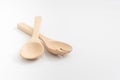 Wooden spoon and fork on white background.