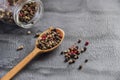 Wooden spoon full of aromatic colorful pepper