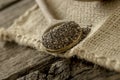 Wooden spoon full of chia seeds lying on a linen textile