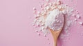 Wooden spoon full of collagen powder, top view, on pink background. Natural supplement for beauty and health of skin, bones,