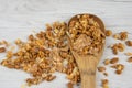 Wooden spoon full of granola on white wood table, top view Royalty Free Stock Photo