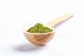 Wooden spoon full of green japanese matcha tea powder on white background. Selective focus, copy space Royalty Free Stock Photo