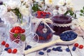 Wooden spoon full of honey berry, vintage jars with fresh berry and jam Royalty Free Stock Photo