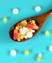 Wooden spoon full of pills, tablets, vitamins, drugs, omega 3 fish oil, gel capsules, medicament and food supplement for health ca Royalty Free Stock Photo
