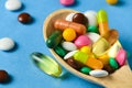 Wooden spoon full of pills, tablets, vitamins, drugs, omega 3 fish oil, gel capsules, medicament and food supplement for health Royalty Free Stock Photo