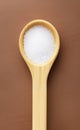 Wooden spoon full of salt