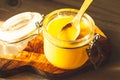 Wooden spoon with ghee - clarified butter on the kitchen