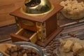 Wooden spoon in a glass jar with coffee beans, coffee grinder, pieces of brown sugar on a wooden background. Close up Royalty Free Stock Photo