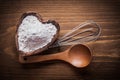 Wooden spoon heartshaped bowl flower egg-whisk food and drink co Royalty Free Stock Photo