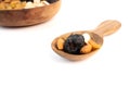 A wooden spoon holds a mix of dates, almonds, and pistachios Royalty Free Stock Photo
