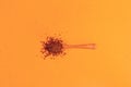 Wooden spoon with instant granulated coffee on a background of neo carrot color top view