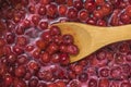 Wooden spoon in the jam from the ripe cherries. Royalty Free Stock Photo