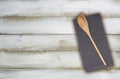 Wooden spoon and kitchen towel on olive white wood