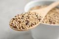 Wooden spoon with mixed quinoa seeds Royalty Free Stock Photo