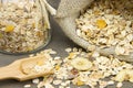 wooden spoon with muesli and burlap sack and jar on the background