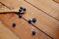 Wooden spoon with oat flakes and blueberry over wooden pattern b Royalty Free Stock Photo