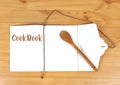 Wooden spoon open cookbook