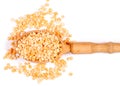 A wooden spoon pile of peas a wooden spoon on a white background