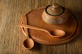 Wooden spoon, plate, clay pot on old table Royalty Free Stock Photo