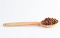 Wooden spoon with raisins on white background. Royalty Free Stock Photo