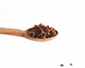 Wooden spoon with raisins on white background. Royalty Free Stock Photo