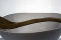 Wooden spoon resting on a glass bowl