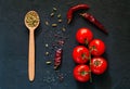 Wooden spoon with spices on dark background.Frame of organic food. The concept of vegetarian food and healthy diet, copy space Royalty Free Stock Photo