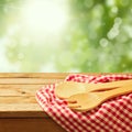 Wooden spoon on tablecloth over garden background Royalty Free Stock Photo