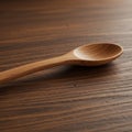 Wooden spoon on a textured wood surface. The spoon features a smooth, rounded Royalty Free Stock Photo