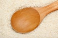 Wooden spoon on Thai fragrant jasmine rice