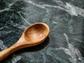 Wooden spoon on wet surface Royalty Free Stock Photo