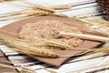 Wooden spoon with wheat bran and wheat ears