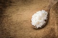 Wooden spoon white boiled rice on wood background Royalty Free Stock Photo