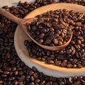 Wooden spoon on wooden surface with spilled roasted coffee beans