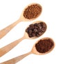 Wooden spoons of beans, instant and ground coffee on white background, top view Royalty Free Stock Photo
