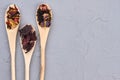 Wooden spoons with different dried tea leaves. Royalty Free Stock Photo