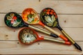 Wooden spoons with floral ornament in traditional folk Russian Khokhloma style on wooden table