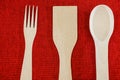 Wooden spoons, fork and spatula on a red background. View from above Royalty Free Stock Photo