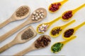 Wooden spoons full of aromatic herbs and spices on a white fabr Royalty Free Stock Photo