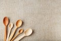 Wooden spoons made of natural wood on burlap fabric as a craft. Royalty Free Stock Photo