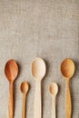 Wooden spoons made of natural wood on burlap fabric as a craft. Royalty Free Stock Photo