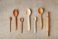 Wooden spoons made of natural wood on burlap fabric as a craft. Royalty Free Stock Photo