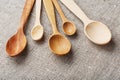 Wooden spoons made of natural wood on burlap fabric as a craft. Royalty Free Stock Photo