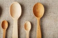 Wooden spoons made of natural wood on burlap fabric as a craft. Royalty Free Stock Photo