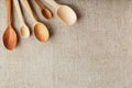 Wooden spoons made of natural wood on burlap fabric as a craft. Royalty Free Stock Photo