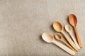 Wooden spoons made of natural wood on burlap fabric as a craft. Royalty Free Stock Photo