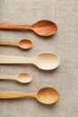 Wooden spoons made of natural wood on burlap fabric as a craft. Royalty Free Stock Photo