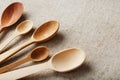 Wooden spoons made of natural wood on burlap fabric as a craft. Royalty Free Stock Photo